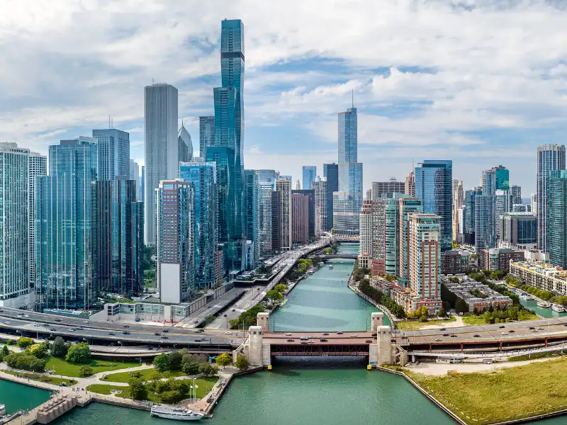Chicago skyline with the Chicago River and a bridge in the foreground.